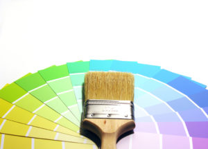 A photo of a paintbrush and swatches